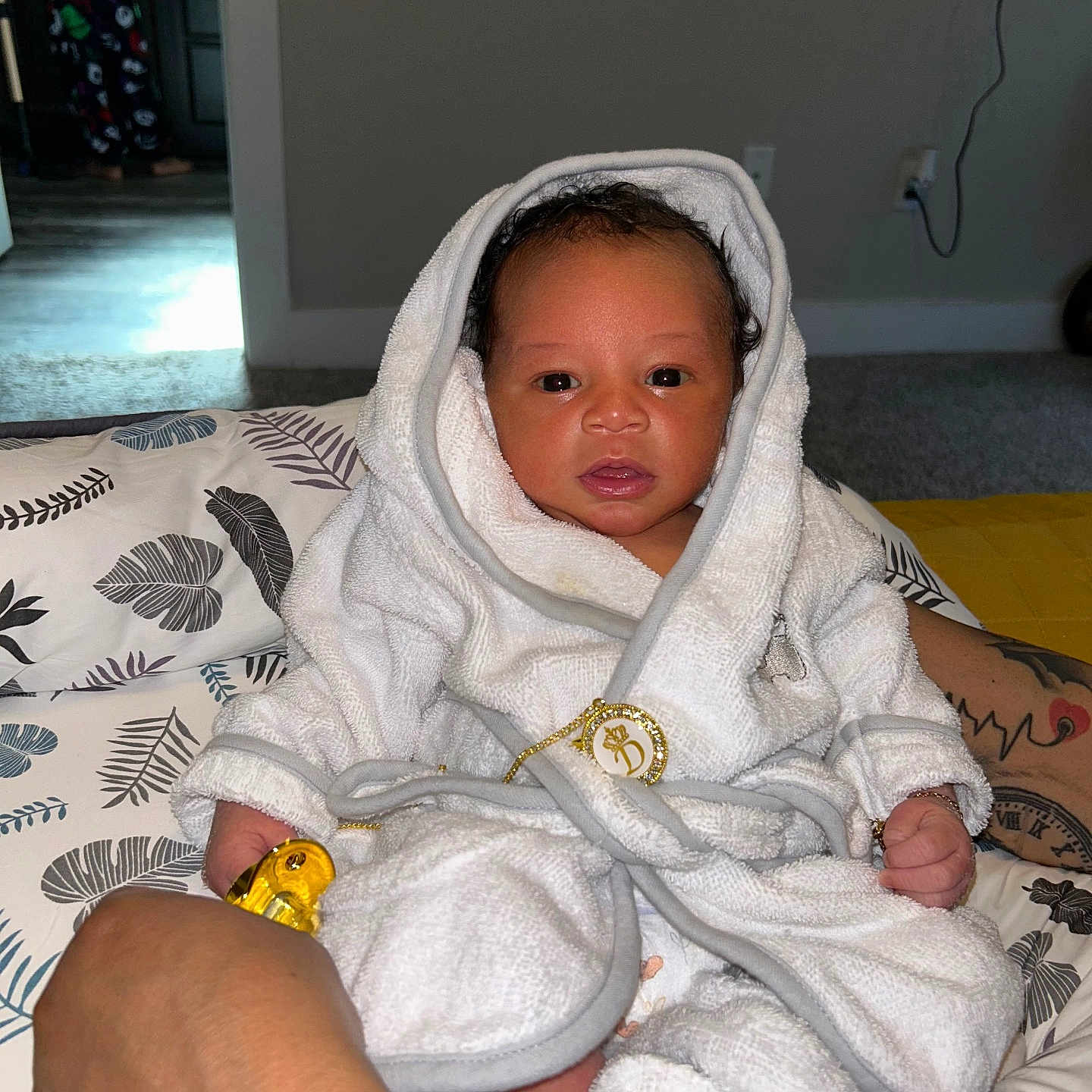 Dallas is registered to the contest to win money with this photo: baby, bed, blanket, bodypart, clothing, face, fashion, finger, footwear, hand, head, newborn, person, photography, portrait, quilt, shoe, skin, tattoo, towel