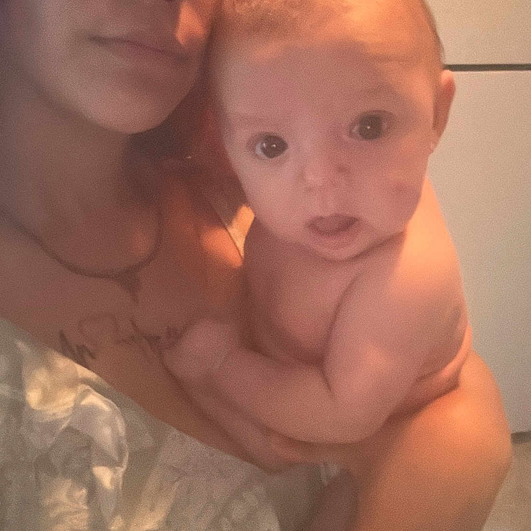 Carson is registered to the contest to win money with this photo: accessories, baby, clothing, dress, earring, face, fashion, formalwear, gown, happy, head, indoors, jewelry, necklace, newborn, person, photography, portrait, selfie, smile