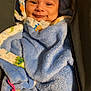 Keanu is registered to the contest to win money with this photo: baby, smiling, blanket, blue_blanket, pacifier, baby_carrier, cozy, infant, cute, face, clothing, child, wrapped, happy, indoor, soft, portrait, small, warm, comfort