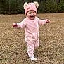 toddler, child, pink_hat, pink_outfit, smiling, walking, grass, outdoor, trees, winter_clothing, happy, nature, baby, cute, fur_pom_poms, one_person, headwear, full_body, cold_weather, playful
