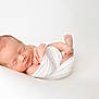 newborn, baby, sleeping, infant, wrapped, white_cloth, peaceful, soft, portrait, closeup, skin, tiny_hands, tiny_feet, resting, cute, fresh, new_life, studio, minimalist, calm