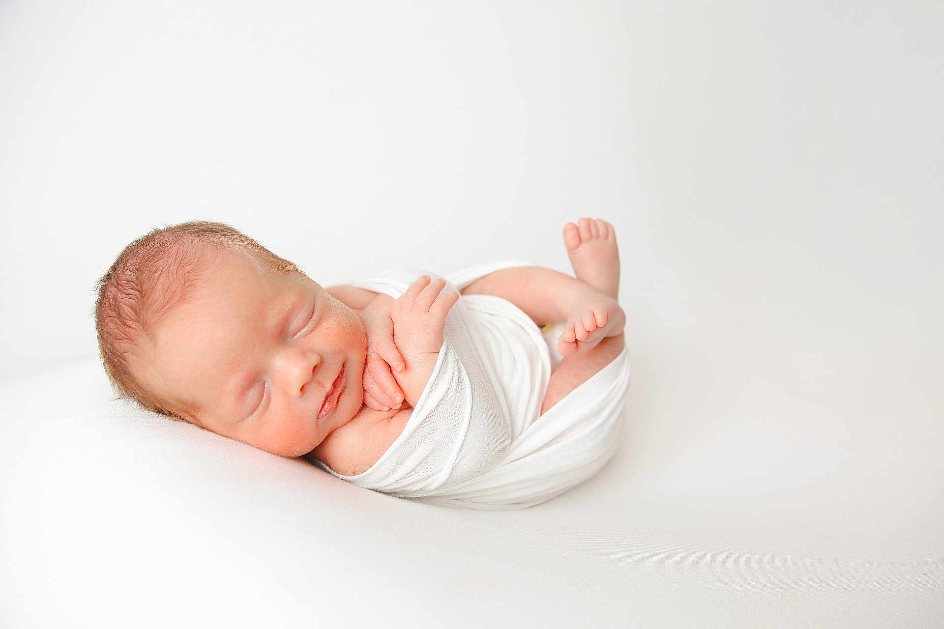 Ryan is registered to the contest to win money with this photo: newborn, baby, sleeping, infant, wrapped, white_cloth, peaceful, soft, portrait, closeup, skin, tiny_hands, tiny_feet, resting, cute, fresh, new_life, studio, minimalist, calm