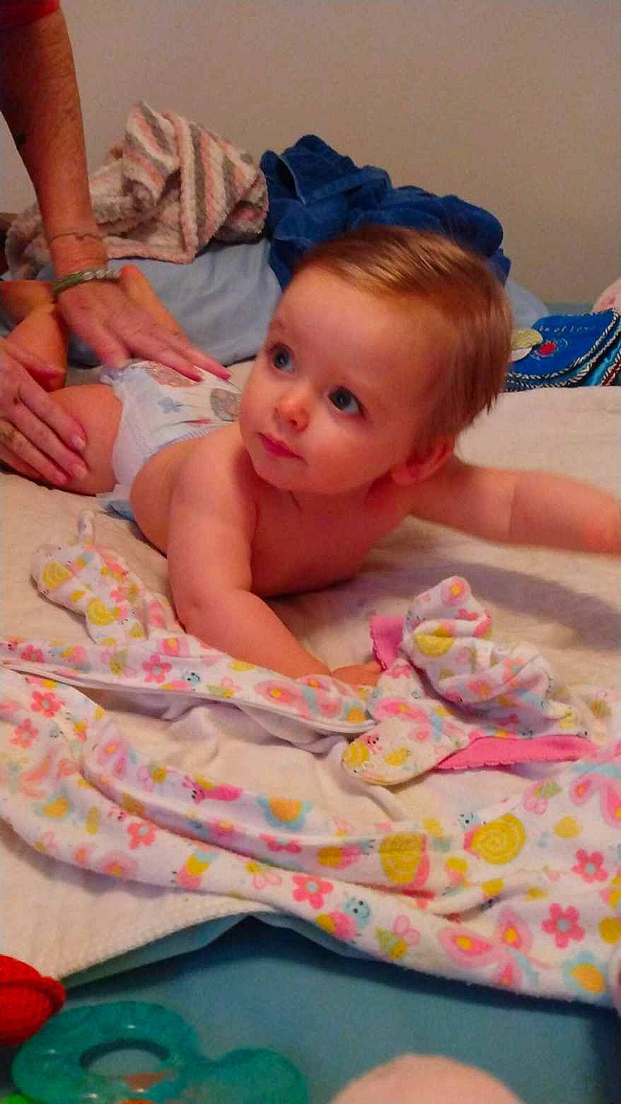 Liberty joined the competition — help win amazing prizes! abdomen, baby, baby_toddler_clothing, bed, bedding, bedtime, cheek, child, comfort, finger, fun, hand, linens, mouth, pattern, person, pink, room, skin, textile