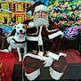 Ranger is registered to the contest to win money with this photo: bench, celebration, christmas, christmas_tree, colorful, decorations, dog, festive, festivity, glasses, harness, holiday, holiday_scene, indoor, painted_background, red_clothing, santa_claus, smiling_dog, white_beard, winter