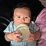 Xavian is registered to the contest to win money with this photo: baby, bottle, infant, hands, blanket, clothing, face, person, lying_down, milk, cute, child, soft_texture, indoors, young, holding, expression, skin, head, toddler