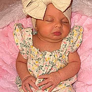 Kinsley joined the competition — help win amazing prizes! baby, sleeping, bow, headband, floral_outfit, pink_blanket, infant, cute, peaceful, hands, closed_eyes, soft_texture, newborn, child, portrait, cozy, indoors, resting, small_hands, cute_outfit