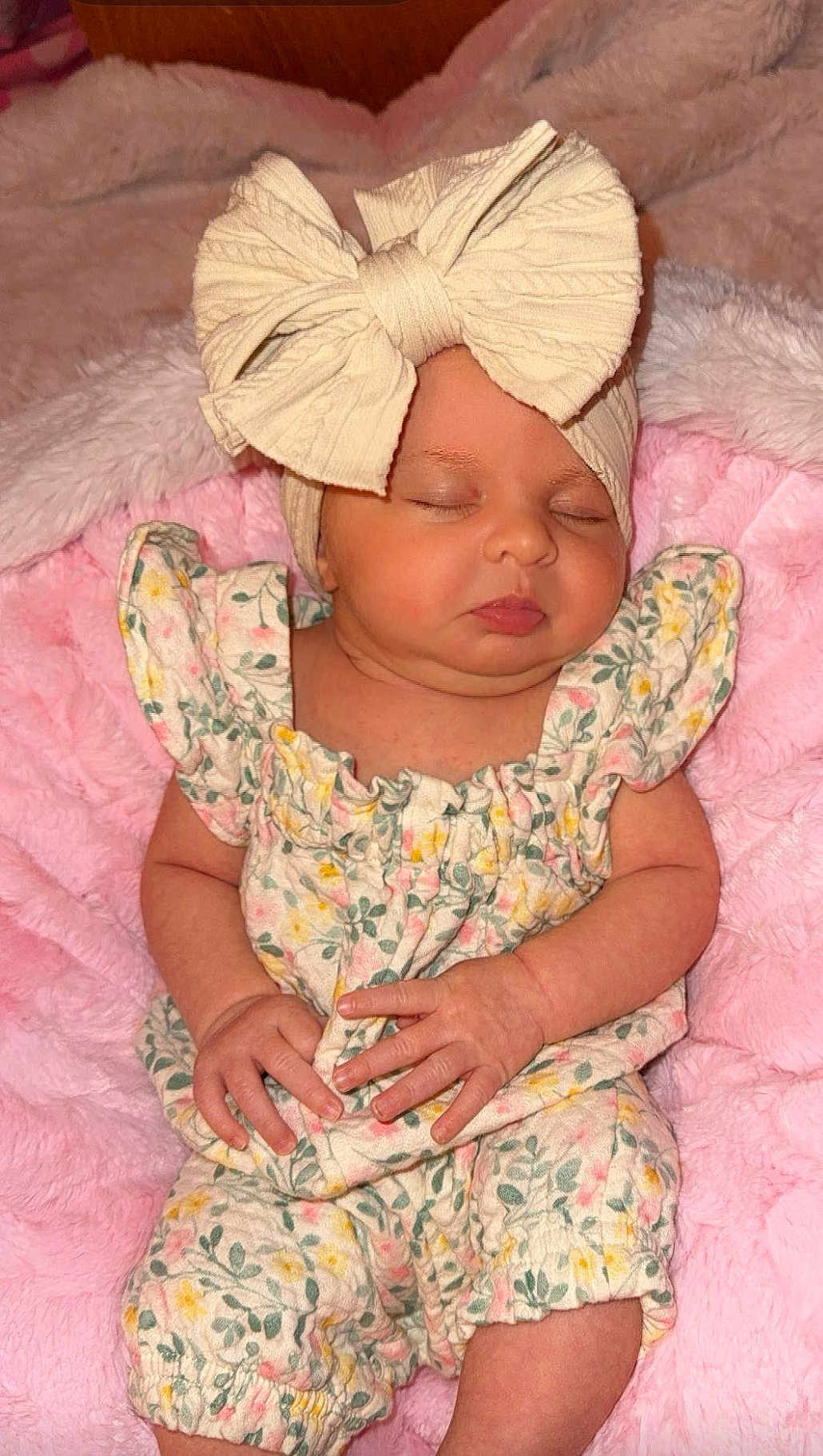 Kinsley joined the competition — help win amazing prizes! baby, sleeping, bow, headband, floral_outfit, pink_blanket, infant, cute, peaceful, hands, closed_eyes, soft_texture, newborn, child, portrait, cozy, indoors, resting, small_hands, cute_outfit