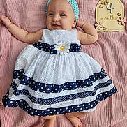 Emily is registered to the contest to win money with this photo: applique, baby, blanket, bonnet, cap, clothing, dress, face, flower, hat, head, homedecor, linen, newborn, pattern, person, photography, plant, portrait, sitting
