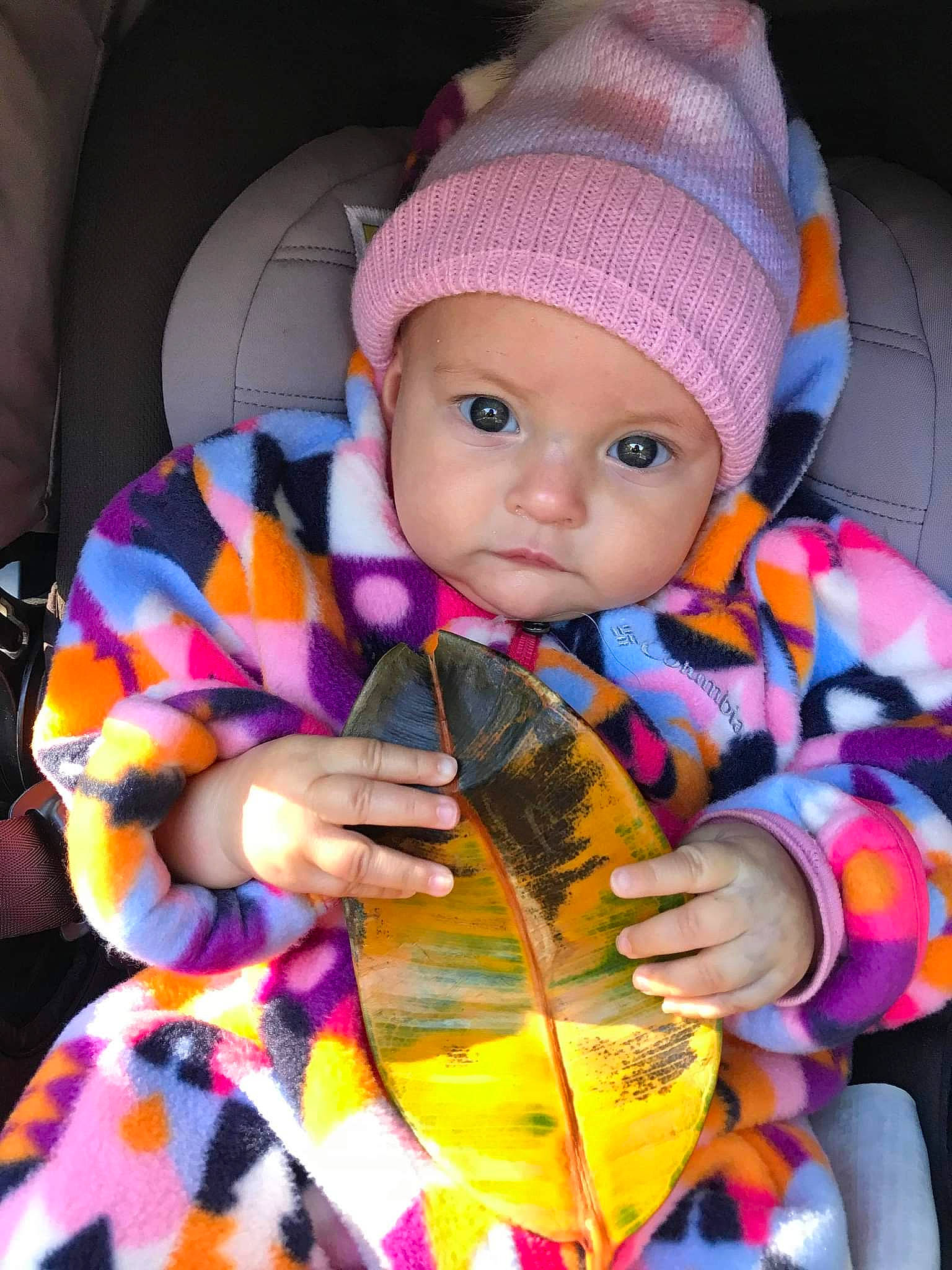 Clara a rejoint le concours — aidez-le/la à gagner de superbes lots ! baby, baby_toddler_clothing, cap, car_seat, cheek, child, cool, eye, fashion_accessory, fun, headgear, headwear, knit_cap, magenta, outerwear, pattern, person, pink, purple, skin