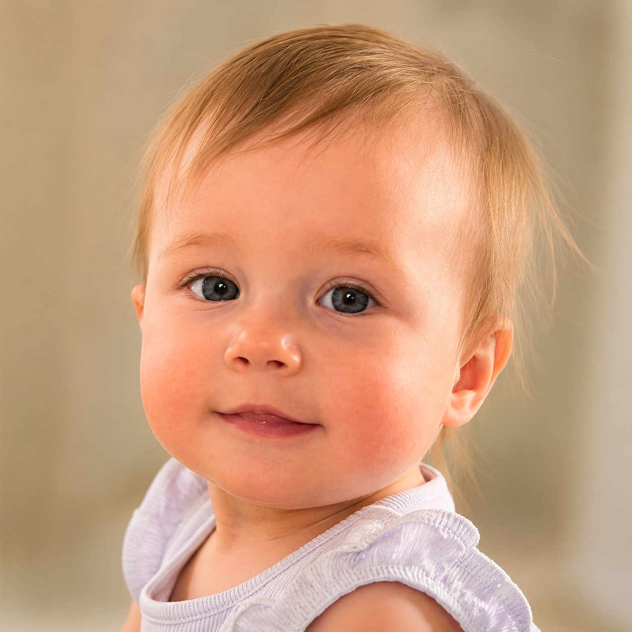 Cecelia is registered to the contest to win money with this photo: baby, child, portrait, face, blue_eyes, smile, light_hair, skin, clothing, purple_outfit, cute, innocent, close_up, soft_background, young, person, baby_face, happy, ruffled_sleeves, indoor