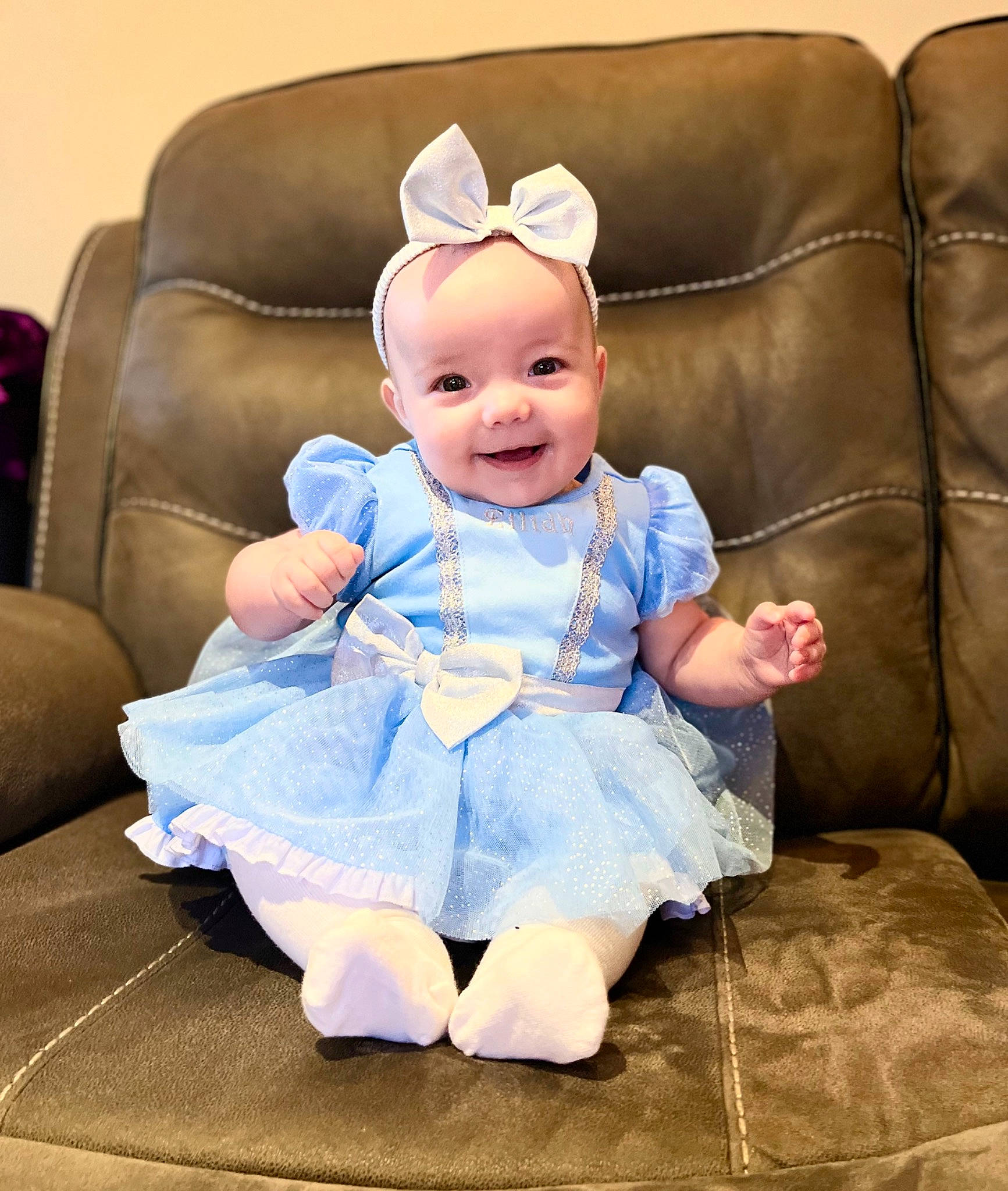 Eilidh joined the competition — help win amazing prizes! baby, baby_toddler_clothing, child, comfort, couch, dress, electric_blue, fashion_accessory, flash_photography, happy, joy, person, product, purple, room, ruffle, sitting, skin, sleeve, smile