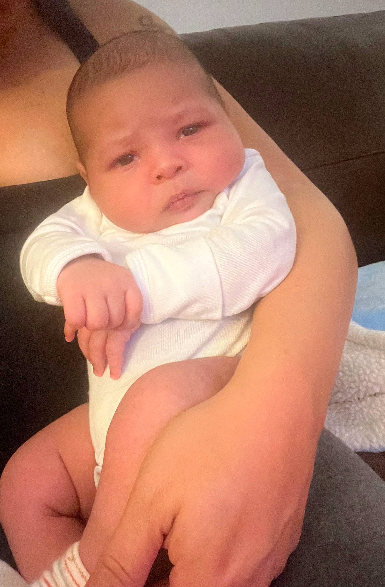 Byron is registered to the contest to win money with this photo: arm, baby, baby_toddler_clothing, cheek, comfort, elbow, eye, finger, gesture, hand, head, human_body, joint, knee, leg, neck, person, skin, stomach, thigh