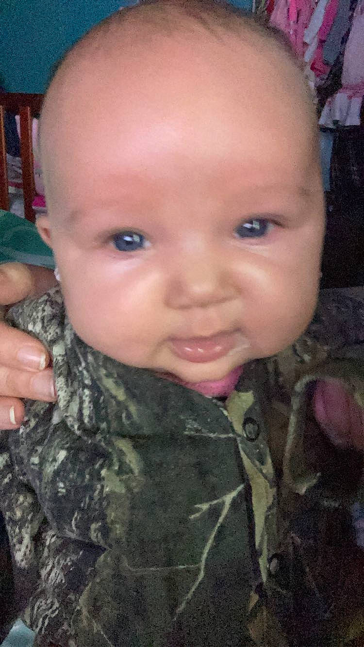 Ariella is registered to the contest to win money with this photo: camouflage, cheek, chin, ear, eyelash, finger, forehead, gesture, hand, head, iris, lip, military_camouflage, mouth, nose, organ, person, skin, smile, thumb