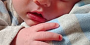 Valentino is registered to the contest to win money with this photo: baby, blanket, bodypart, face, finger, hand, head, newborn, person, photography, portrait, quilt, sleeping, towel