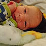 Valentino is registered to the contest to win money with this photo: baby, bed, blanket, bodypart, bonnet, clothing, crib, face, finger, furniture, hand, hat, head, infantbed, newborn, person, photography, portrait, quilt, towel