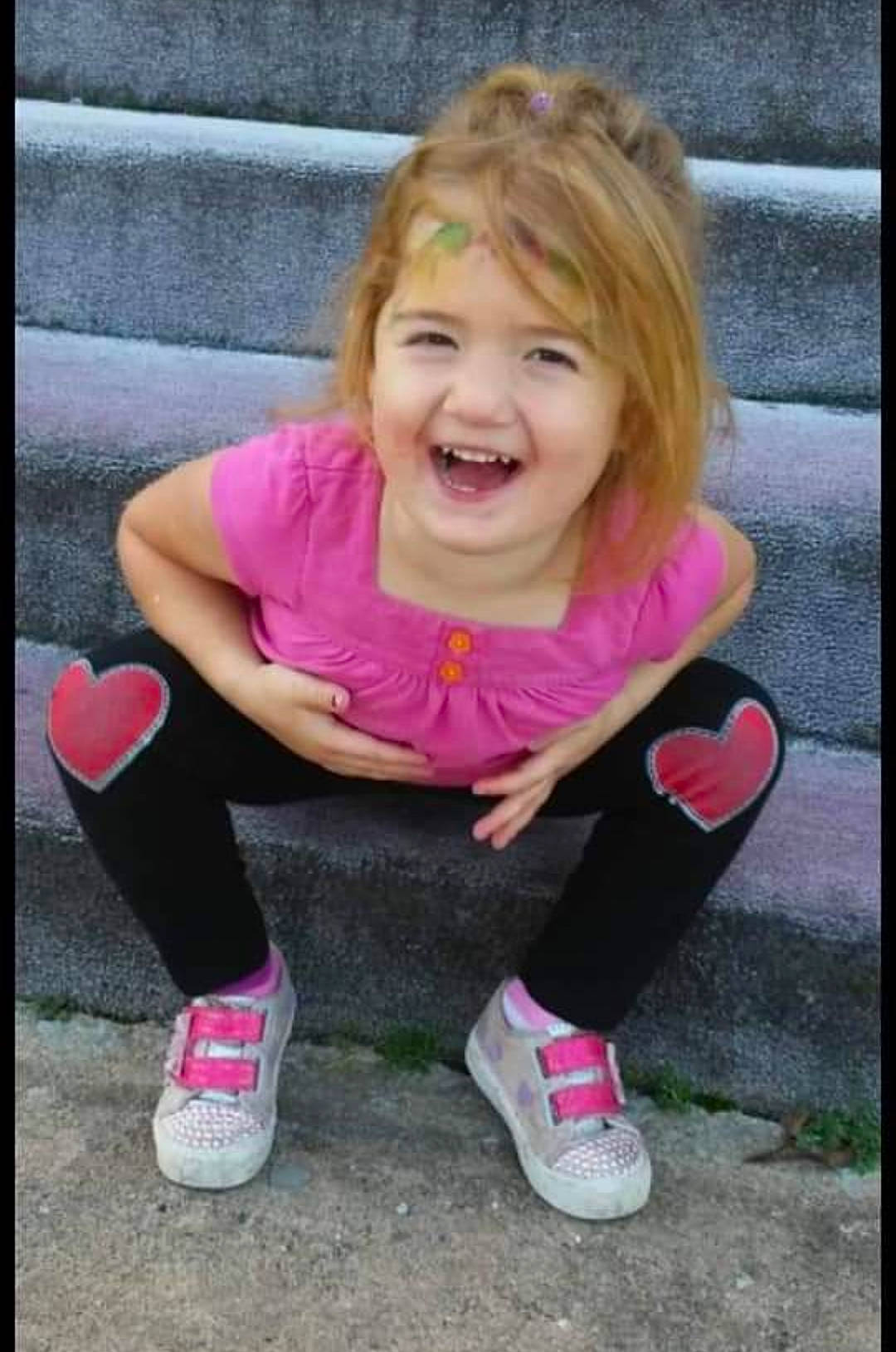 Mackenzie is registered to the contest to win money with this photo: baby_toddler_clothing, cheek, cool, facial_expression, footwear, fun, grass, hair, hairstyle, happy, head, joy, lip, magenta, person, pink, skin, smile, sneakers, sock