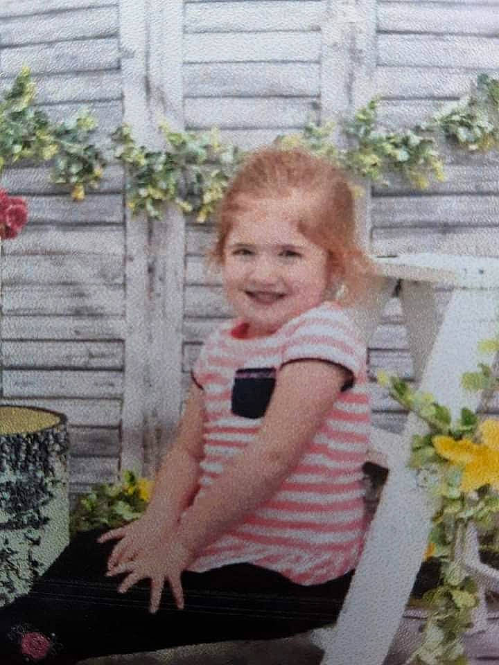 Mackenzie is registered to the contest to win money with this photo: baby_products, baby_toddler_clothing, backyard, child, fun, garden, grass, happy, joy, pattern, people_in_nature, person, pink, plant, shorts, shrub, sitting, sleeve, smile, t_shirt