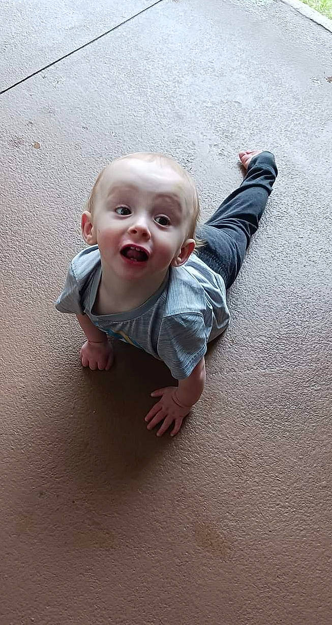 Kacen is registered to the contest to win money with this photo: asphalt, baby, baby_toddler_clothing, carmine, child, concrete, flash_photography, floor, flooring, fun, gesture, grey, happy, person, road_surface, sand, sleeve, smile, surprise, t_shirt