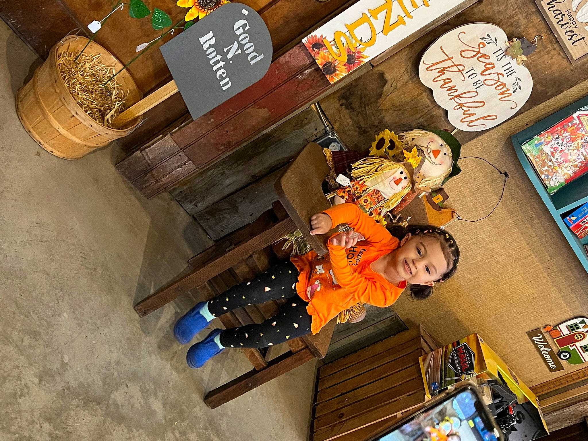 Odessa is registered to the contest to win money with this photo: box, convenience_store, fiction, fictional_character, font, fun, games, hardwood, joy, machine, person, publication, retail, room, toddler, toy, wood