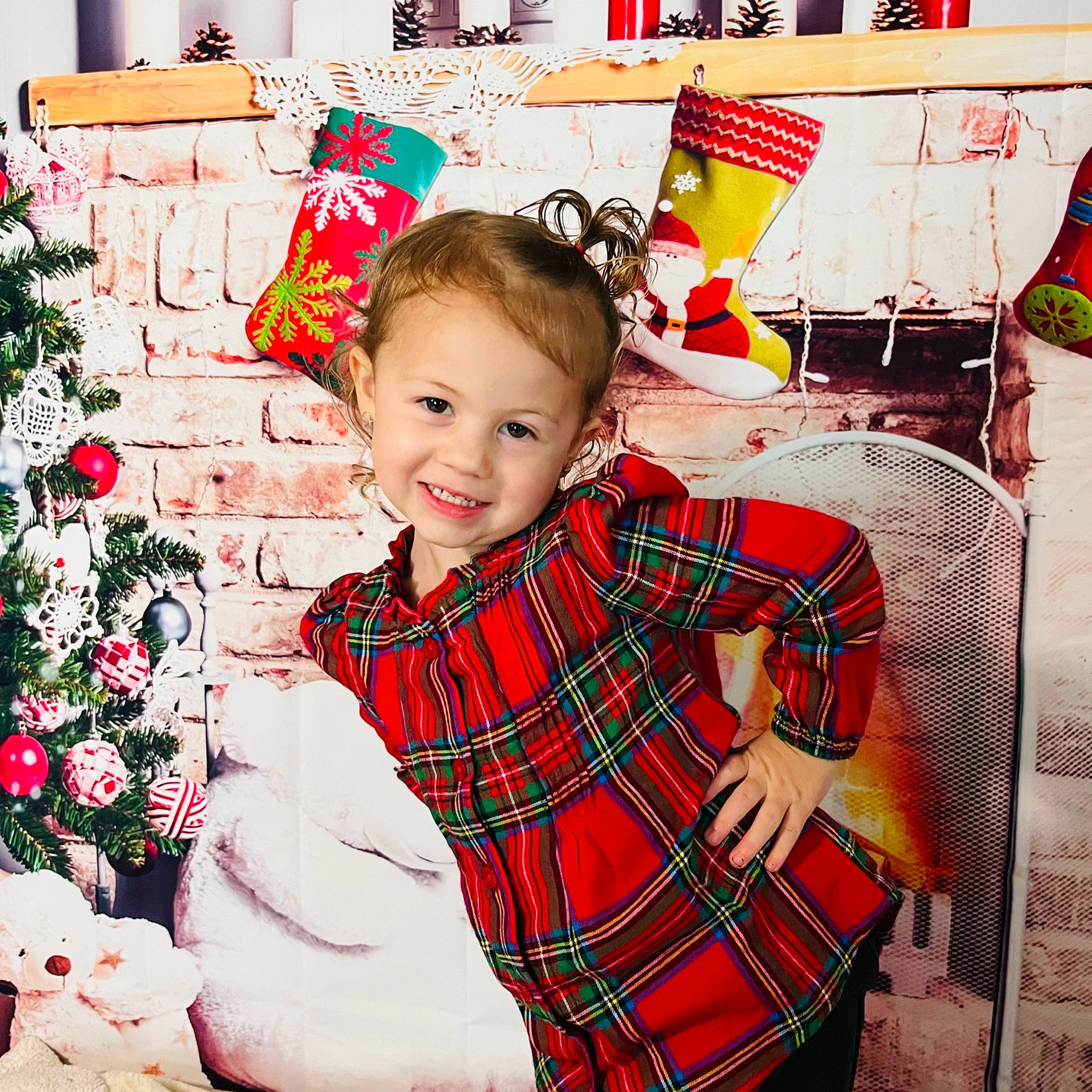 Everleigh is registered to the contest to win money with this photo: baby_toddler_clothing, child, christmas, christmas_eve, christmas_ornament, christmas_tree, event, green, happy, head, holiday, joy, pattern, person, plaid, red, sleeve, smile, sock, tartan