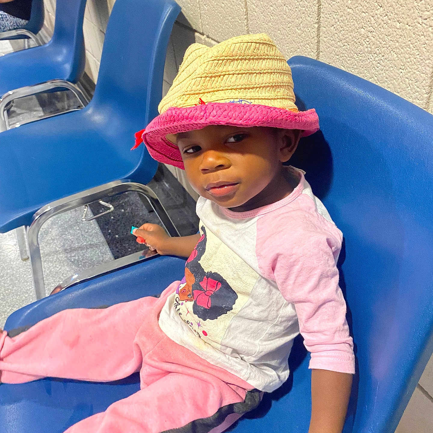 Honesty is registered to the contest to win money with this photo: adult, baby, cap, chair, clothing, face, female, furniture, hat, head, person, photography, portrait, racket, sitting, sleeve, sport, sunhat, tennis, woman