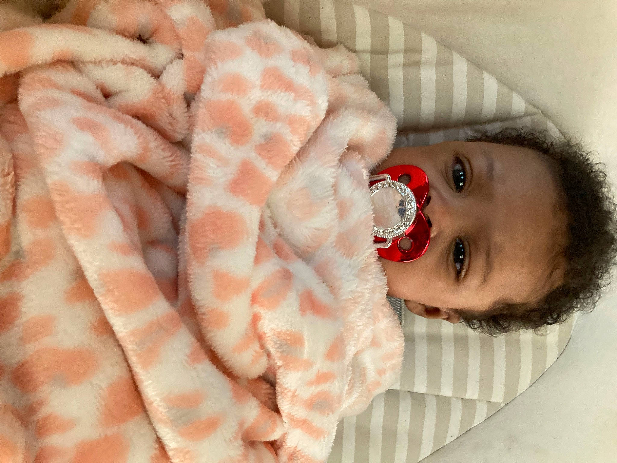Nevaeh joined the competition — help win amazing prizes! baby, baby_toddler_clothing, child, close_up, comfort, eyelash, flooring, fur, gesture, headgear, human_body, linens, lip, mouth, pattern, peach, person, skin, textile, thumb