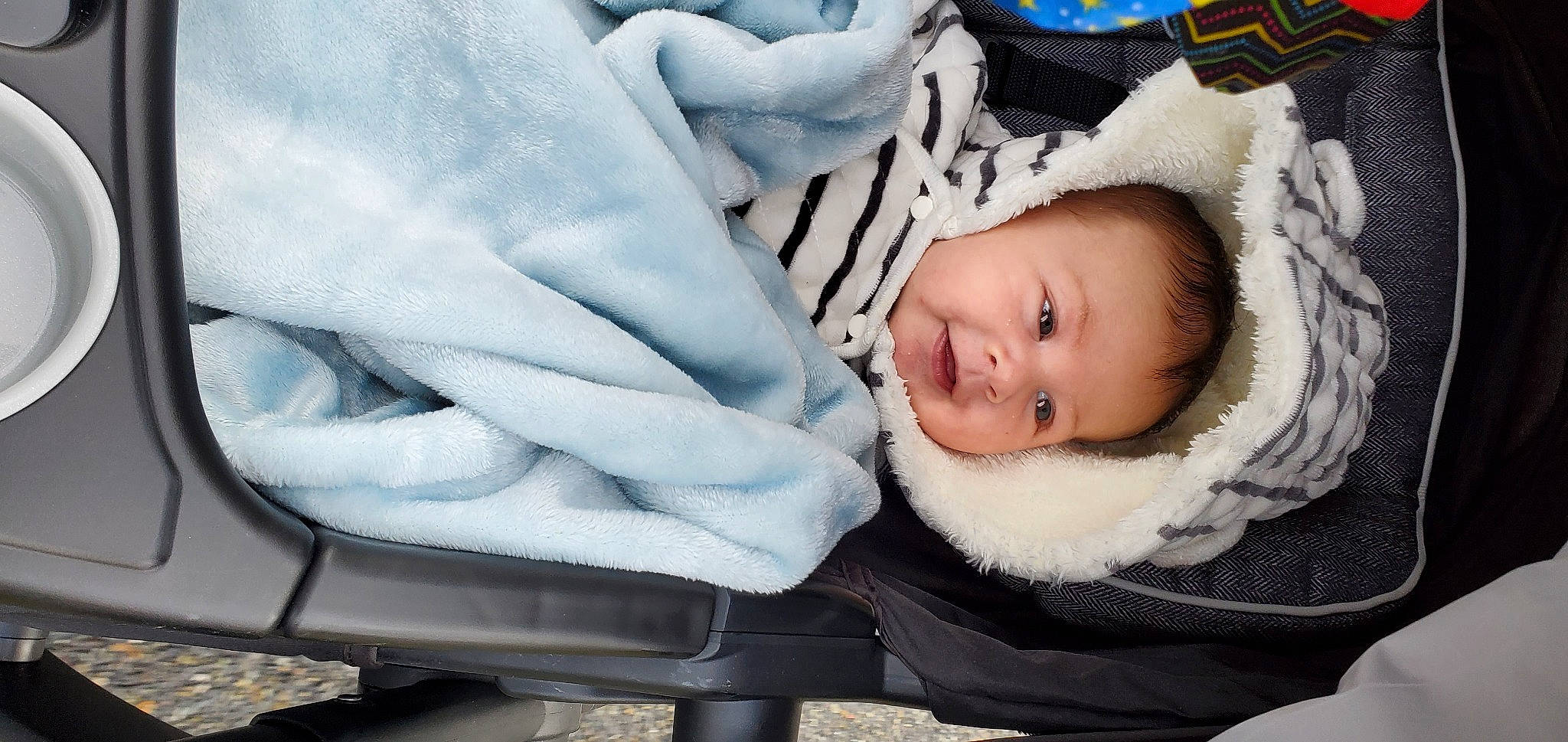 Drake is registered to the contest to win money with this photo: baby, baby_carriage, baby_products, baby_toddler_clothing, beanie, cheek, child, comfort, facial_expression, freezing, fur, happy, outerwear, person, portrait_photography, sitting, skin, smile, textile, toddler