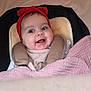 baby, smile, red_headband, car_seat, blanket, cute, child, happy, infant, face, portrait, cozy, cushion, clothing, indoor, headwear, young_child, comfort, seatbelt, toddler