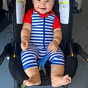 Axel is registered to the contest to win money with this photo: baby, baby_outfit, blue, bright, child, cute, feet, footwear, happy, indoor, infant, legs, person, portrait, red, sitting, smiling, striped_clothing, stroller, young_child