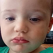 Oakley is registered to the contest to win money with this photo: baby, casual_clothing, child, closeup, contemplative, curly_hair, expression, eyes, face, green_shirt, hair, head, indoor, mouth, person, portrait, skin, toddler, young_boy, young_child