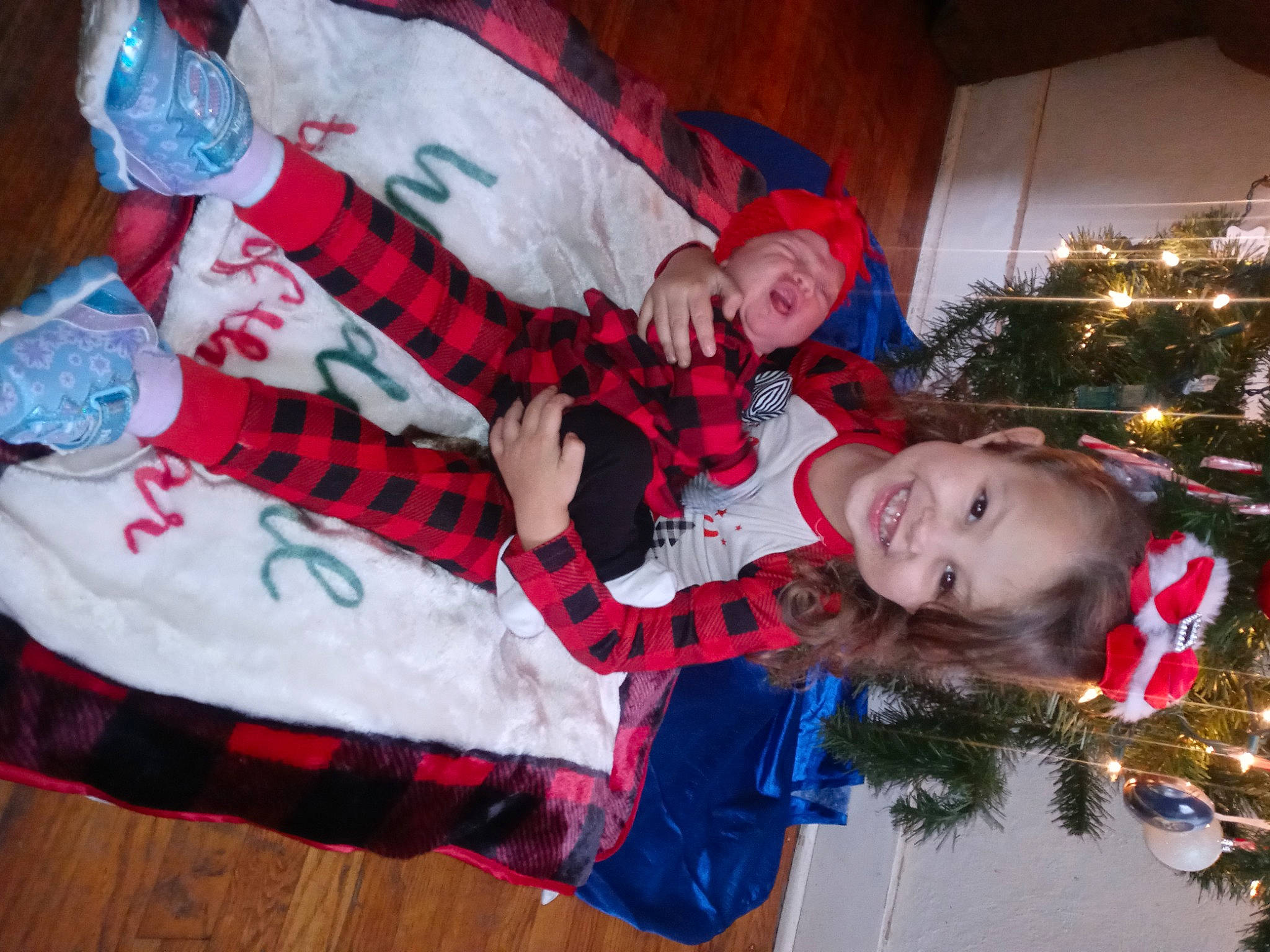 Mylayah is registered to the contest to win money with this photo: carmine, child, christmas, christmas_eve, event, fun, happy, holiday, joy, lap, leisure, pattern, person, plaid, plant, red, sleeve, smile, tartan, tradition