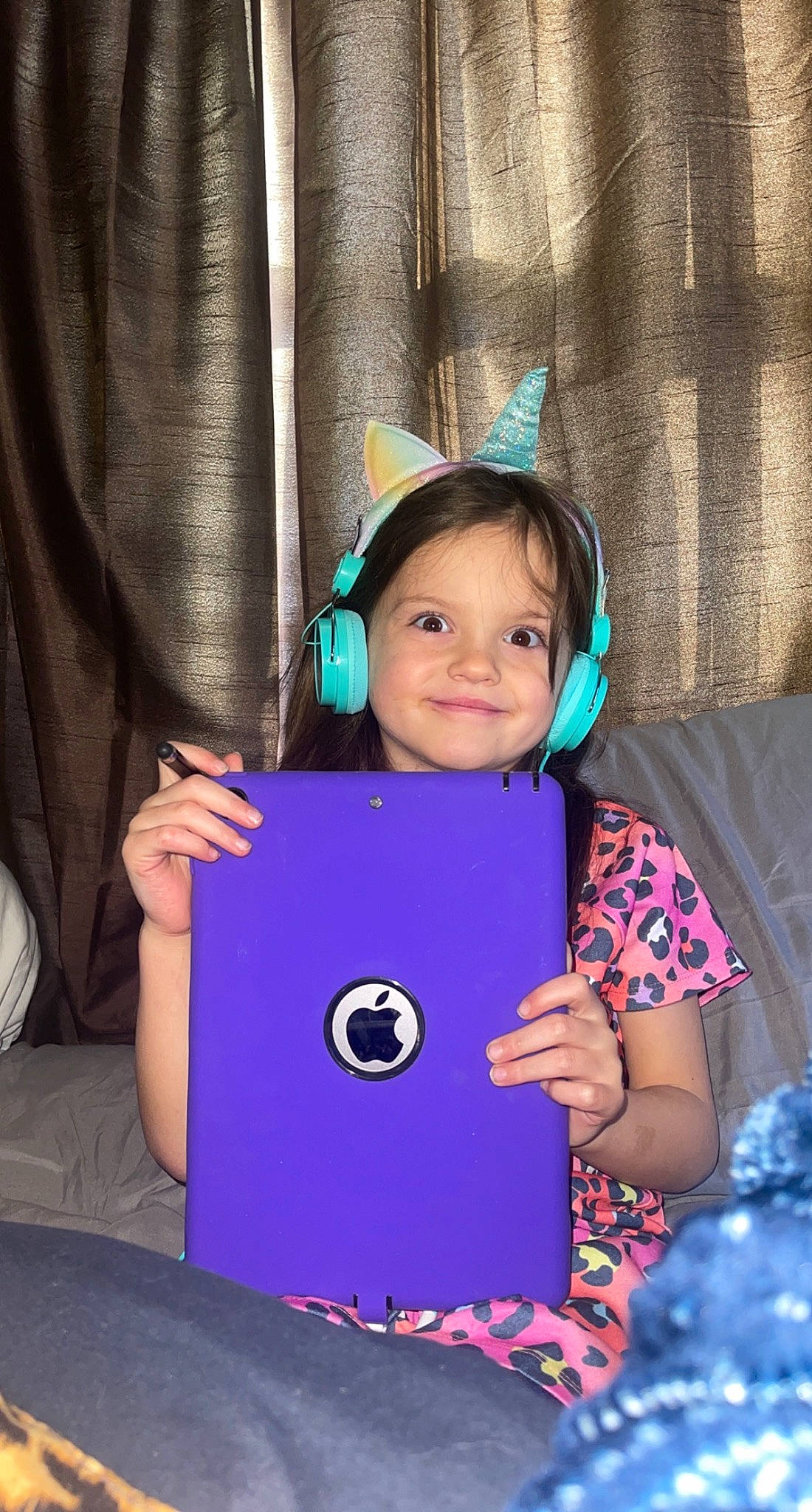 Kayson is registered to the contest to win money with this photo: azure, bag, child, electric_blue, event, fashion_accessory, fun, gadget, happy, joy, leisure, magenta, person, pink, purple, recreation, sitting, sleeve, smile, t_shirt