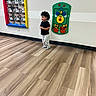 Roberto joined the competition — help win amazing prizes! black_shirt, bright_colors, child, colorful_frame, curly_hair, flooring, indoor, interactive_toy, mirror, pajama_pants, person, play_area, reflection, smile, standing, toddler, wall, wall_toy, wooden_floor, young_child