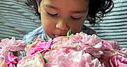 Roberto joined the competition — help win amazing prizes! bouquet, child, closed_eyes, closeup, curly_hair, cute, face, flora, flowers, indoor, nature, peaceful, person, pink, plant, portrait, smelling, soft_light, tender, young