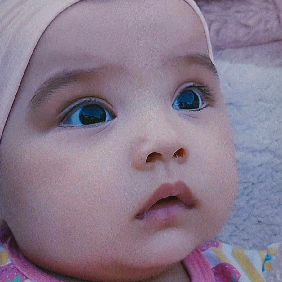 Osiyo joined the competition — help win amazing prizes! adorable, baby, child, close_up, clothing, colorful, curious_eyes, cute, expression, face, headband, indoors, infant, looking_up, pink, plush, portrait, soft_background, striped, young