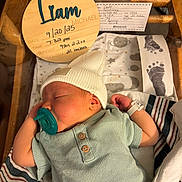 Liam joined the competition — help win amazing prizes! newborn, baby, sleeping, pacifier, hat, hospital, blanket, footprints, wooden_sign, clothing, infant, crib, hospital_bracelet, portrait, baby_bed, swaddled, cute, resting, bed, hospital_room