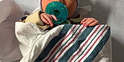 Paisley is registered to the contest to win money with this photo: newborn, baby, pacifier, bow_hat, blanket, hospital_bed, sleeping, infant, striped_blanket, wrapped, toddler, child, person, sleep, cute, small_hands, pink_blue, soft, resting, indoors