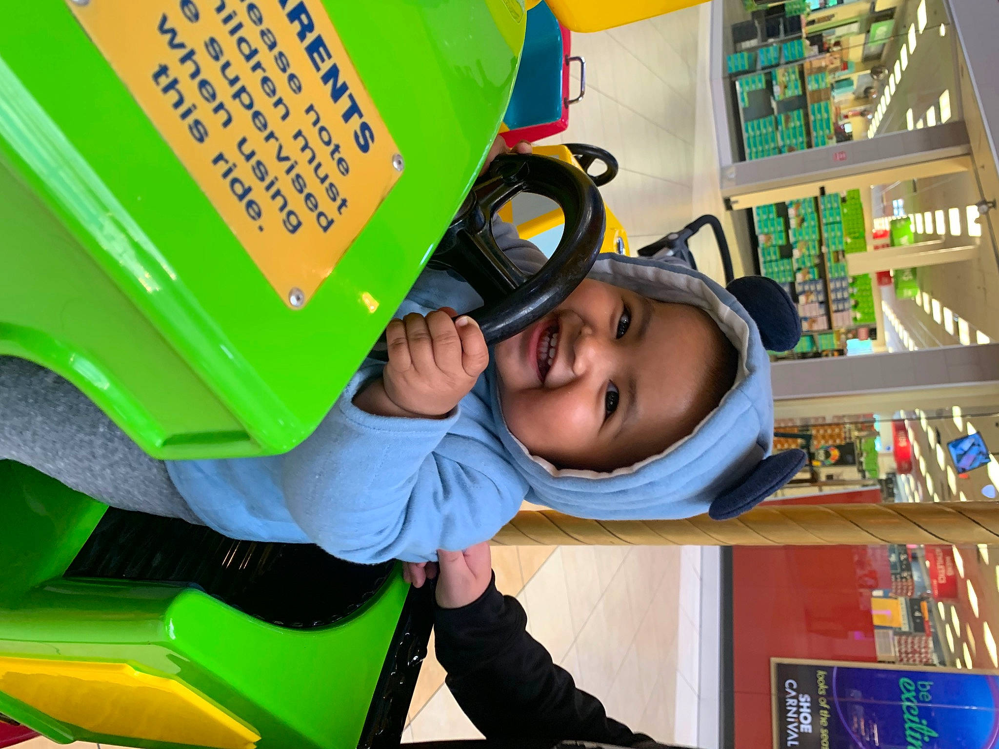 James joined the competition — help win amazing prizes! bookcase, child, facial_expression, fun, green, happy, headwear, joy, kindergarten, learning, leisure, motor_vehicle, person, play, publication, recreation, room, shelf, shelving, smile