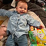Jade participe au concours pour gagner de l'argent avec cette photo : baby, child, smiling, blue_shirt, jeans, plush_toy, play_mat, book, colorful, animal_print, indoor, cute, happy, infant, person, soft_toys, fabric, face, lying_down, cozy