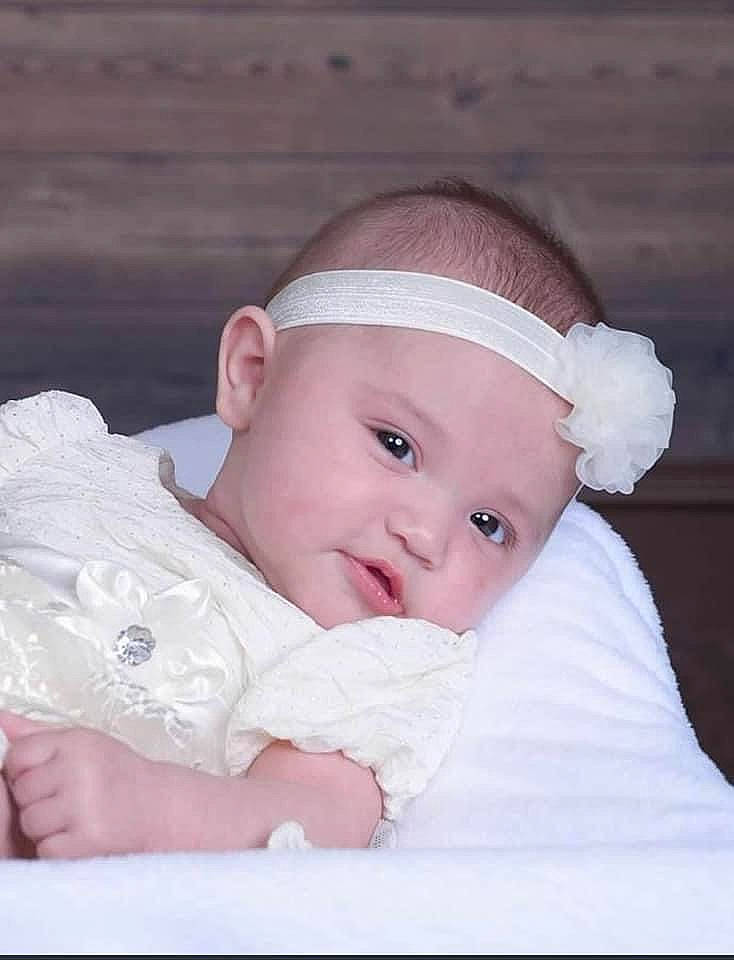 Lillyana is registered to the contest to win money with this photo: baby, baby_products, baby_toddler_clothing, cheek, child, comfort, eye, fashion_accessory, flash_photography, grass, happy, headgear, headwear, iris, linens, lip, person, portrait_photography, sitting, skin