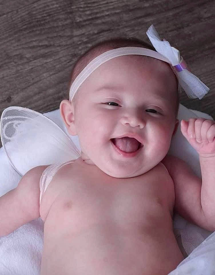 Lillyana is registered to the contest to win money with this photo: arm, baby, cheek, eye, eyebrow, face, facial_expression, gesture, hand, happy, head, headwear, iris, lip, mouth, muscle, neck, nose, person, skin