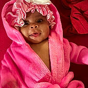 Nova Reign is registered to the contest to win money with this photo: baby, blanket, bonnet, bunny_ears, child, closeup, clothing, cute, face, happy, indoors, infant, pink_robe, portrait, smiling, soft, toddler, tongue_out, warm, young_child