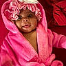 baby, blanket, bonnet, bunny_ears, child, closeup, clothing, cute, face, happy, indoors, infant, pink_robe, portrait, smiling, soft, toddler, tongue_out, warm, young_child