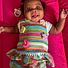 Nova Reign is registered to the contest to win money with this photo: baby, cheerful, child, colorful_clothing, crocheted_flowers, cute, face, hand, happy, indoors, infant, lying_down, pacifier, pink_blanket, playful, portrait, skin, smiling, striped, young_child