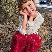 Yuvonne is registered to the contest to win money with this photo: child, smiling, red_dress, white_sweater, tree, outdoor, grass, snow, car, winter, happy, face, portrait, nature, cute, young, person, seasonal, ground, daylight