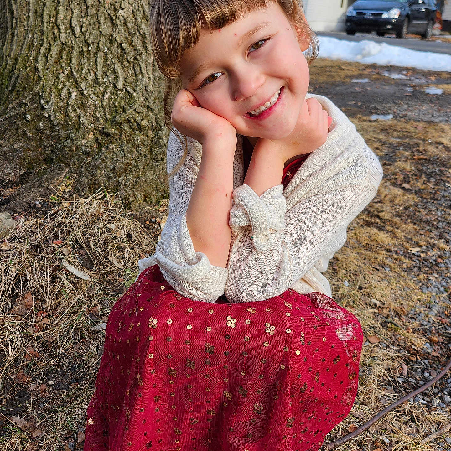 Yuvonne is registered to the contest to win money with this photo: car, child, cute, daylight, face, grass, ground, happy, nature, outdoor, person, portrait, red_dress, seasonal, smiling, snow, tree, white_sweater, winter, young