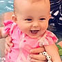 Lya a rejoint le concours — aidez-le/la à gagner de superbes lots ! baby, smiling, pink_swimsuit, water, pool, child, happy, holding_hands, bracelet, swimming, face, cute, summer, outdoor, person, playful, splash, fun, joy, infant