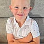 Enzo a rejoint le concours — aidez-le/la à gagner de superbes lots ! child, boy, smiling, blonde_hair, white_shirt, polo_shirt, arms_crossed, couch, gray_couch, indoor, portrait, happy, casual_clothing, short_sleeves, young_child, sitting, face, person, cute, relaxed