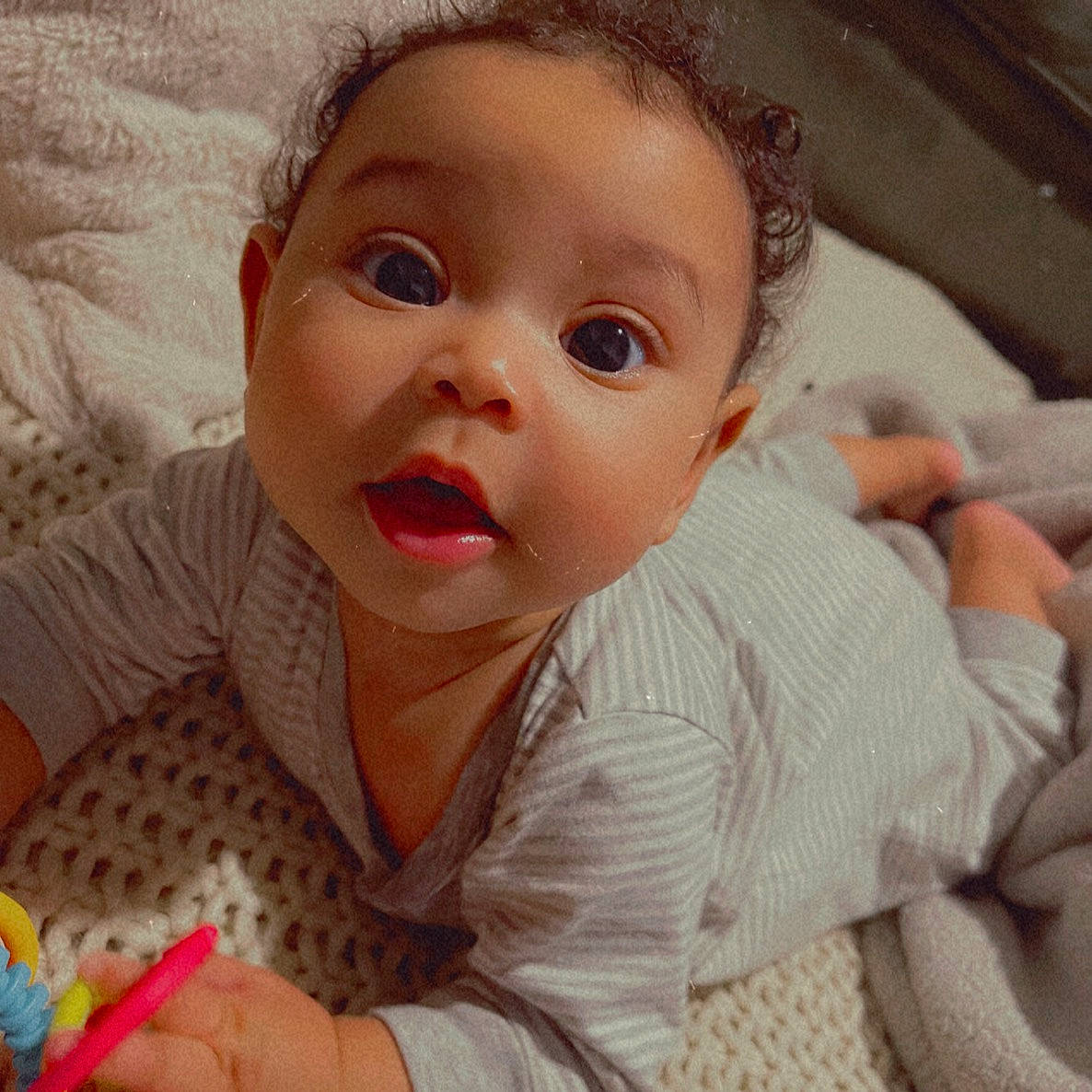 Kehlani is registered to the contest to win money with this photo: baby, baby_toddler_clothing, cheek, child, comfort, ear, eyelash, facial_expression, finger, happy, iris, linens, lip, mouth, nose, person, skin, sleeve, smile, surprise