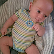 Kolton is registered to the contest to win money with this photo: baby, blanket, child, comfort, cushioned_seat, cute, foot, gazing, head, indoor, infant, legs, onesie, person, plush_toy, relaxed, seated, small_hands, soft_toys, striped_clothing